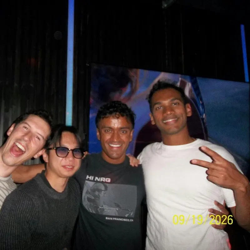 Four friends grinning for the camera on a night out